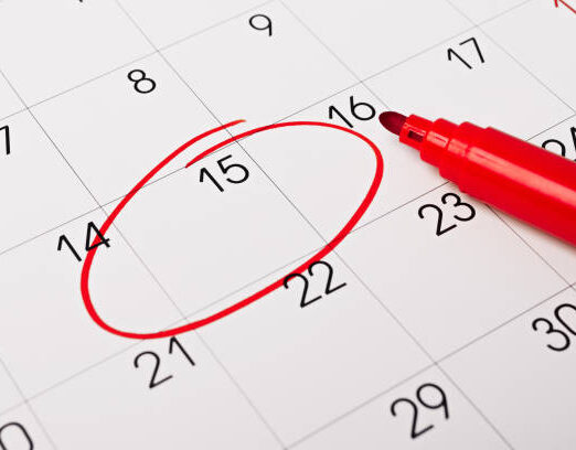 Calendar page with red pen close up. Focus on number 15 in calendar and empty red circle for design in your ideas and work concept