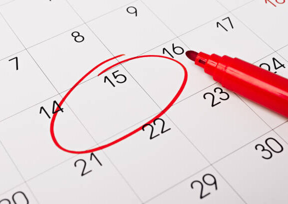Calendar page with red pen close up. Focus on number 15 in calendar and empty red circle for design in your ideas and work concept